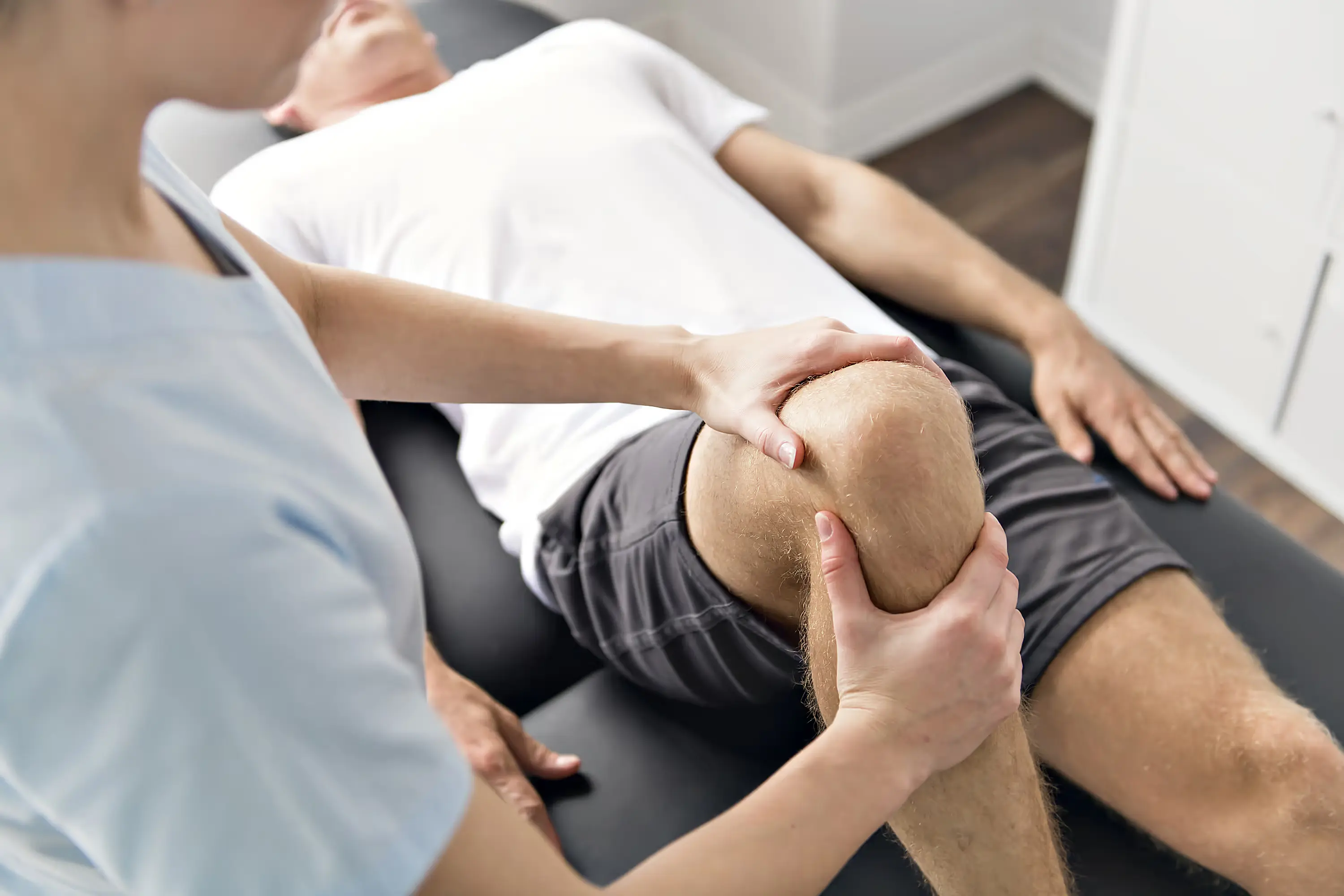 a person receiving physiotherapy on their knee
